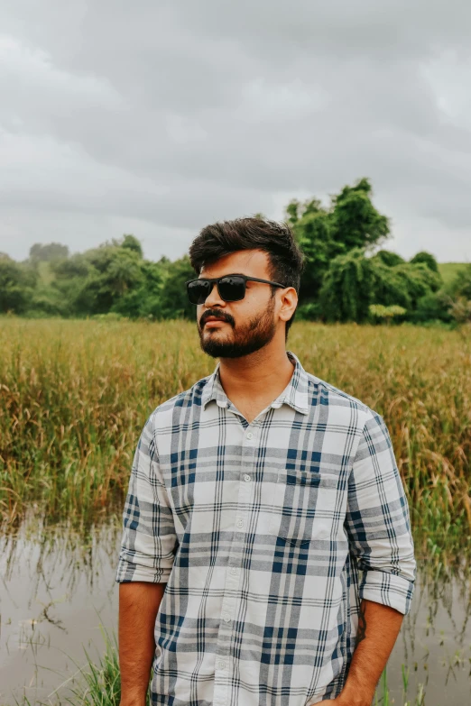 a man standing in front of a body of water