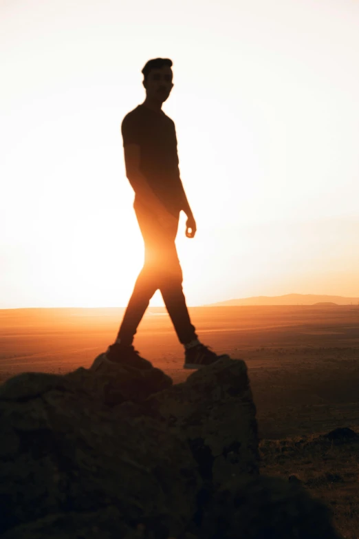 the man is walking through the field alone