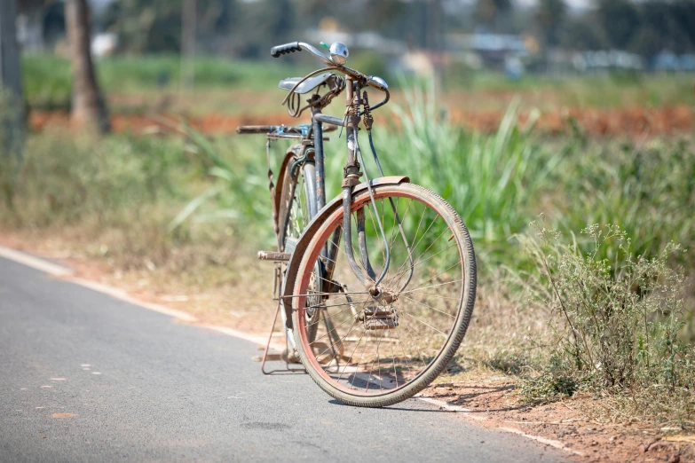 the old bicycle is parked next to the street