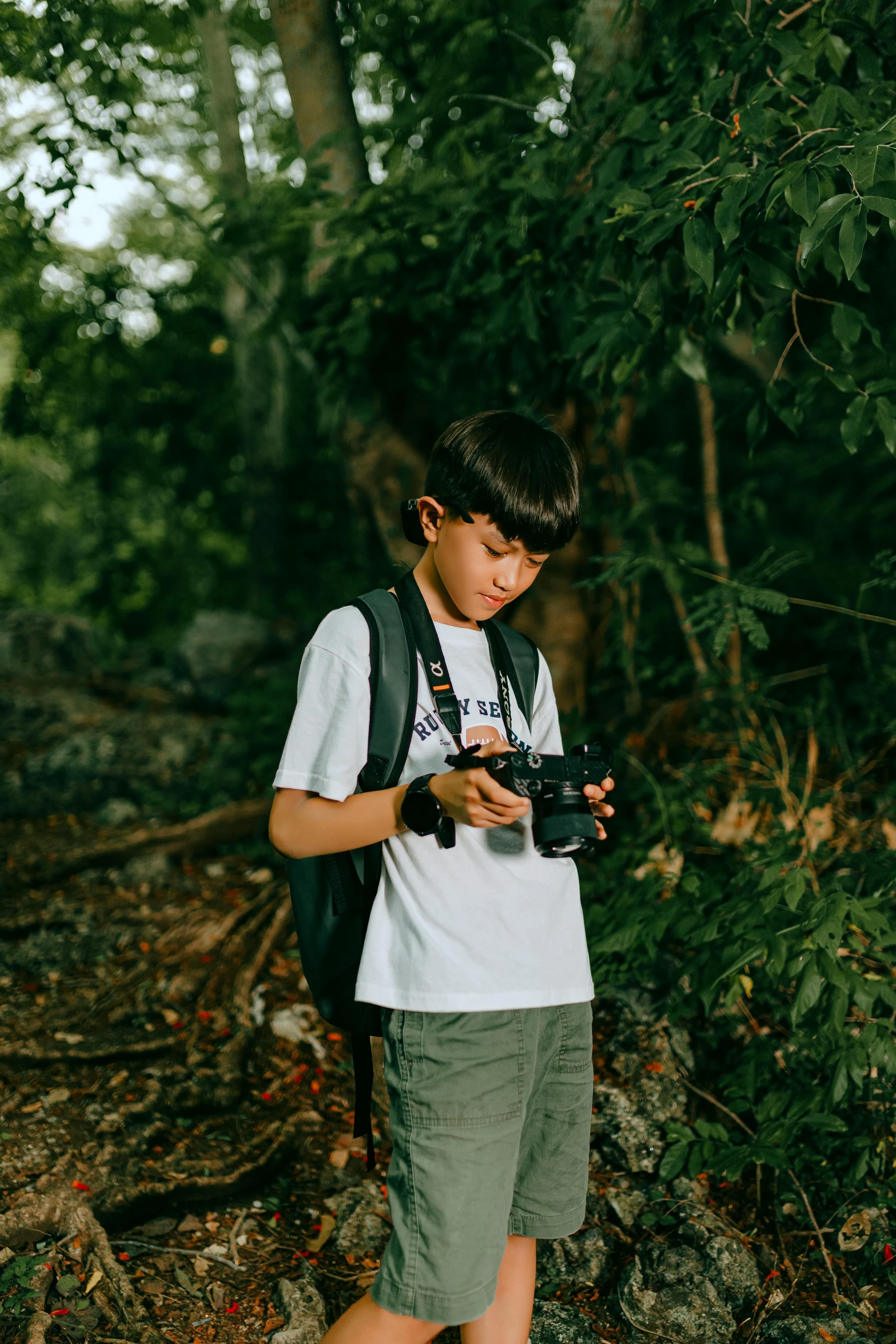  standing in the woods taking pictures