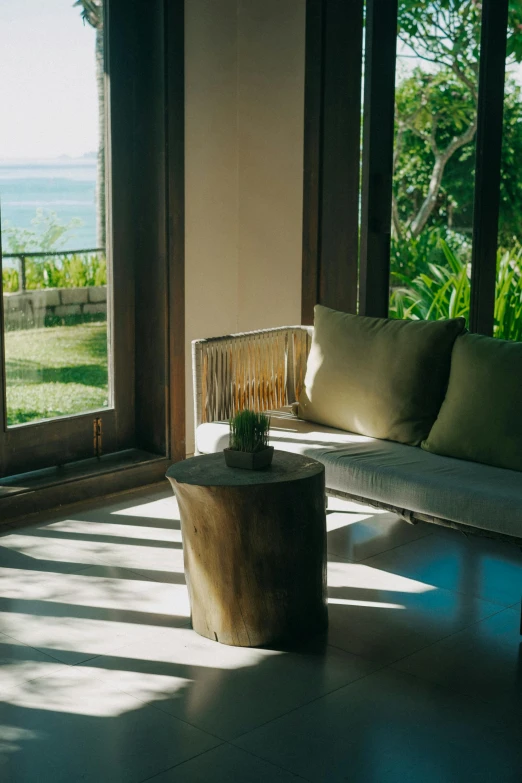 an outside living room with furniture and plants