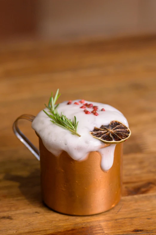 a small copper cup topped with soing white and orange