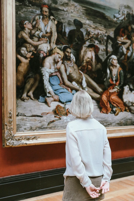 a person standing in front of a painting