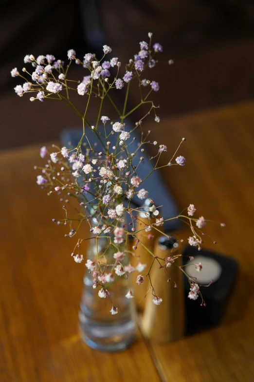 a vase with some pretty pink flowers inside of it