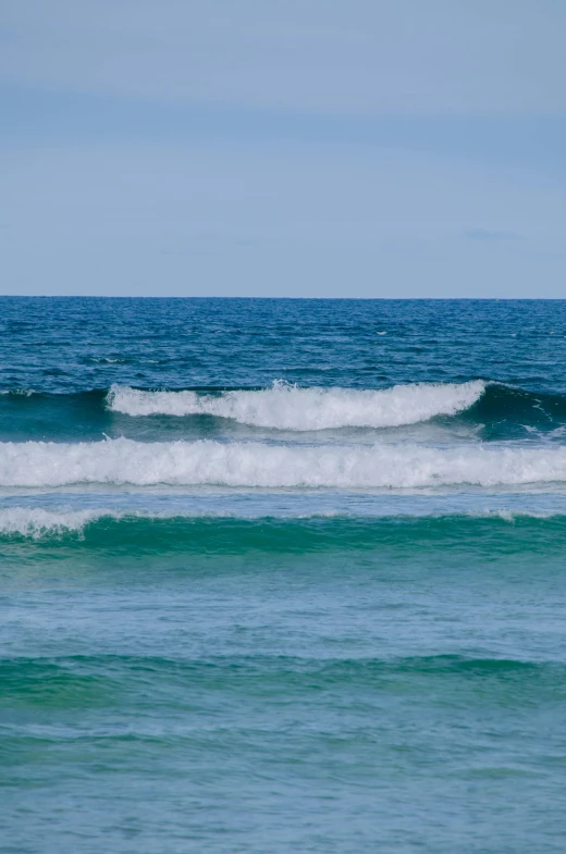 an ocean view of blue water with waves