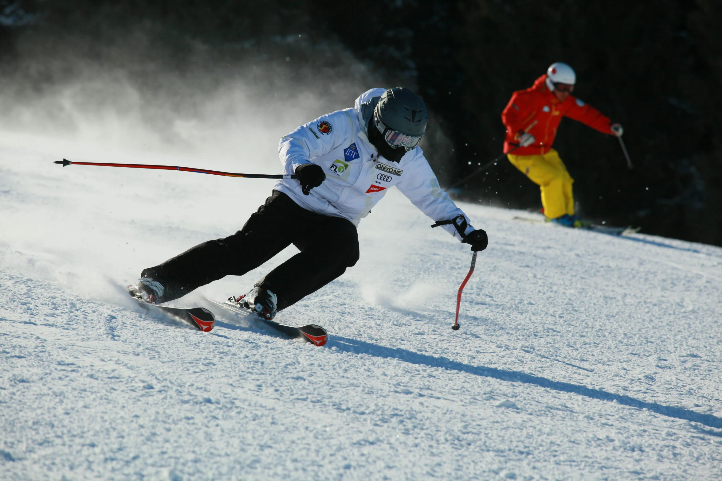 a man riding skis down a snow covered slope