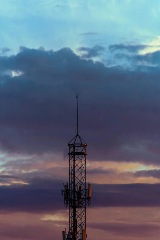 the tower is standing at sunset looking very tall