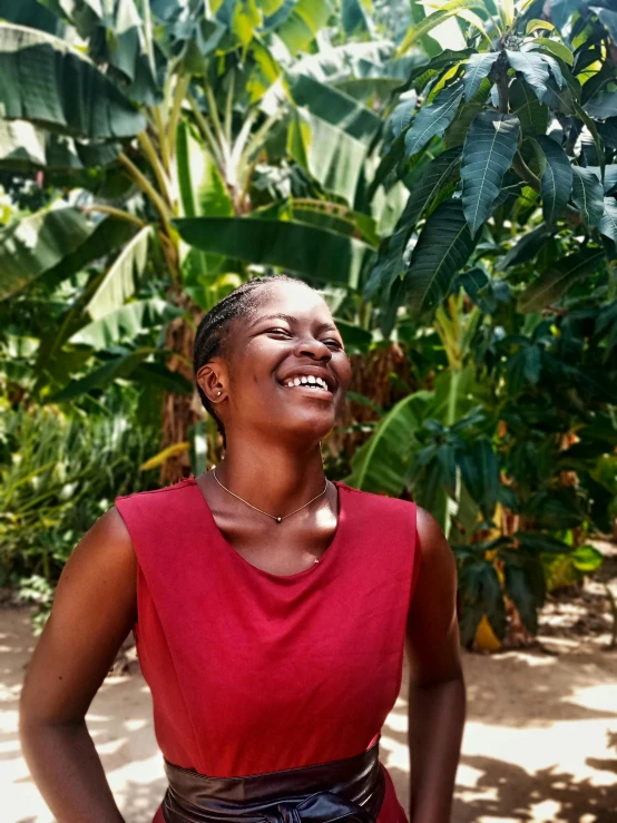 a woman standing next to some tropical plants