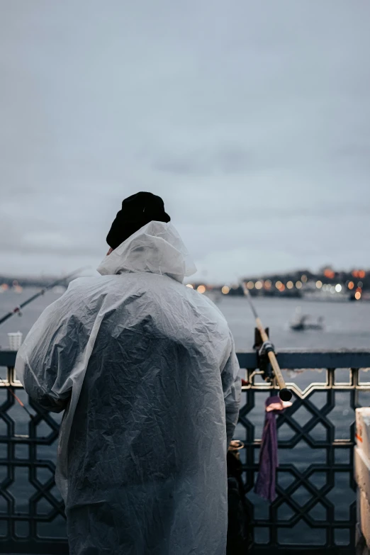 man in a protective suit stands near a fence