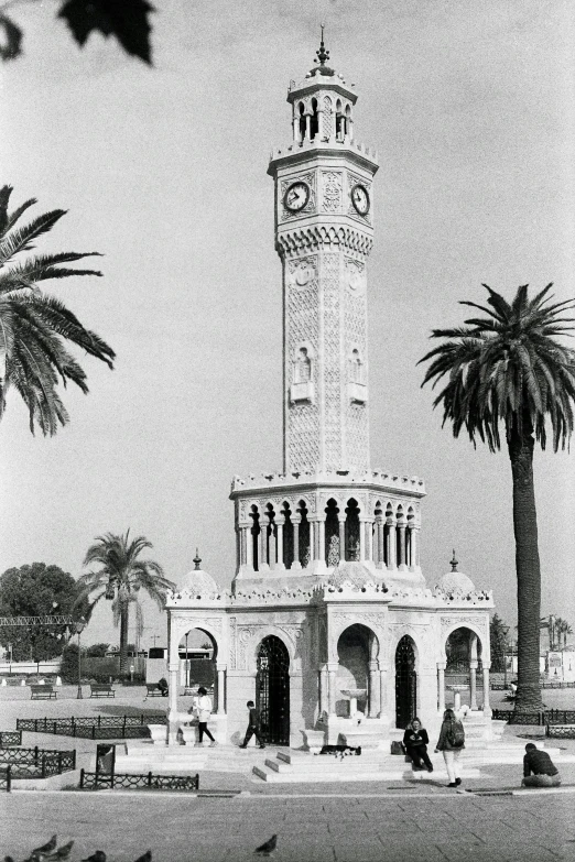 a big building with a clock at the top and trees