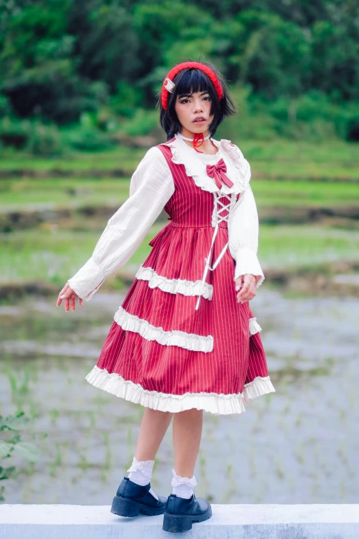 the little girl in a dress and bonnet is posing for the camera