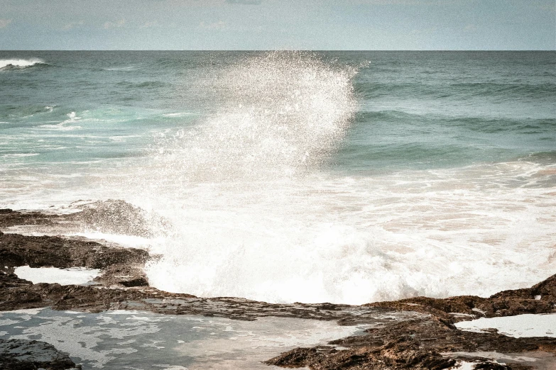 a large wave is crashing in the ocean