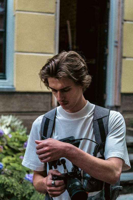 a young man with a backpack and camera