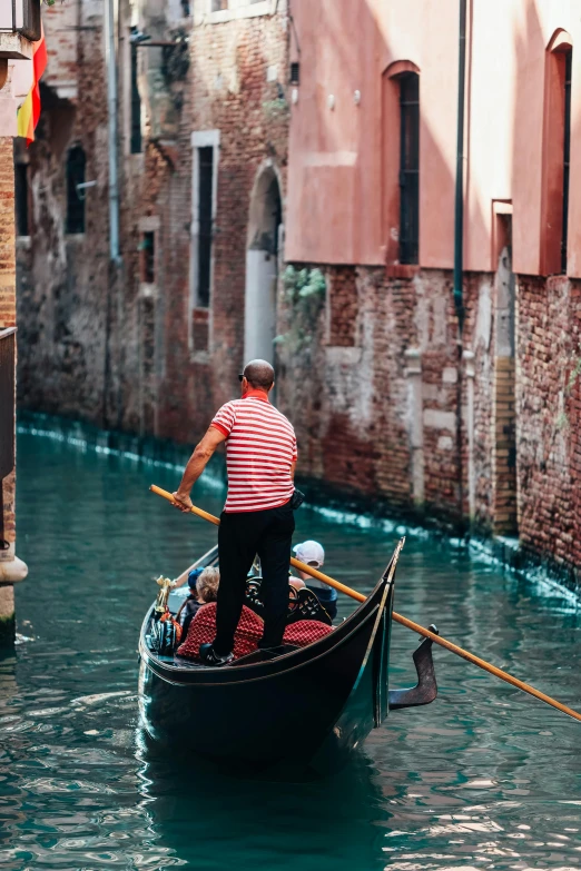 a man is in his gondola and waving to another person