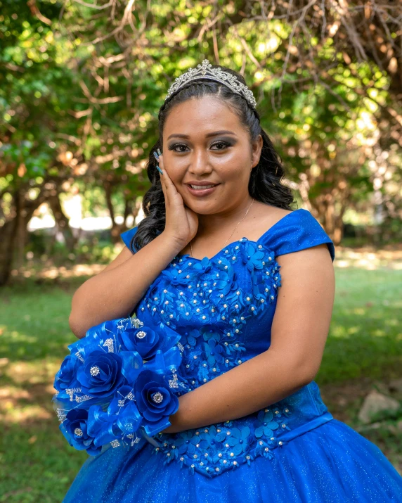 a beautiful young lady dressed in blue posing for a picture