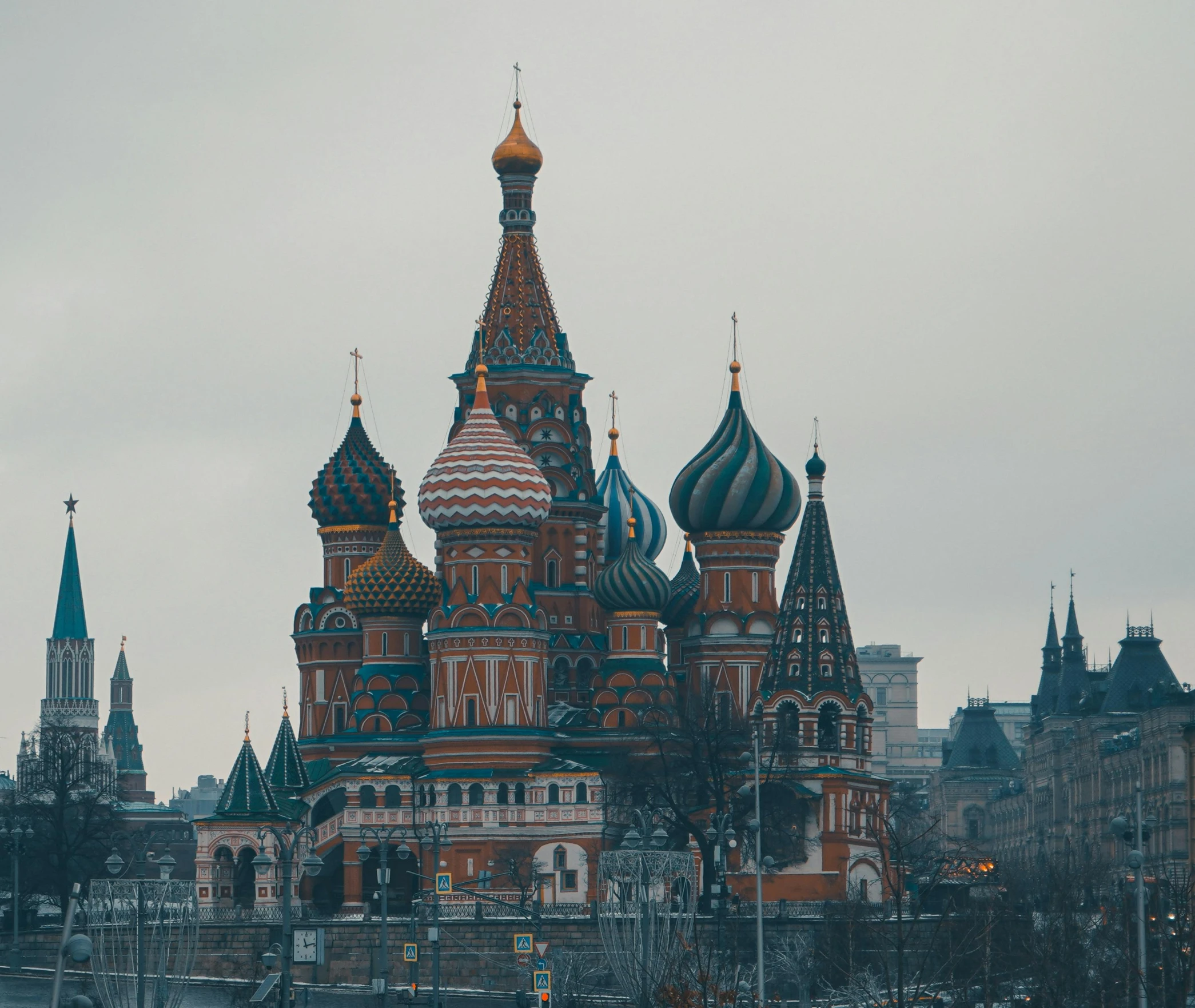 a cathedral with many towers stands in front of a body of water