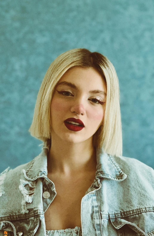 a close up of a person with a jean jacket on