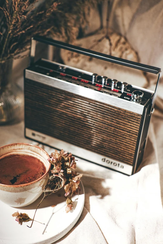 the bowl of soup and radio set are setting on a saucer