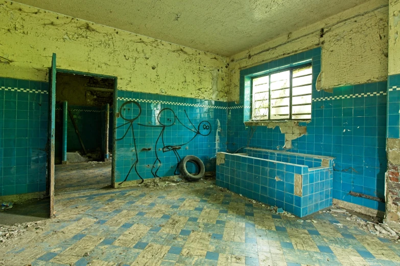 a room in an old house with a few walls and floor tiles