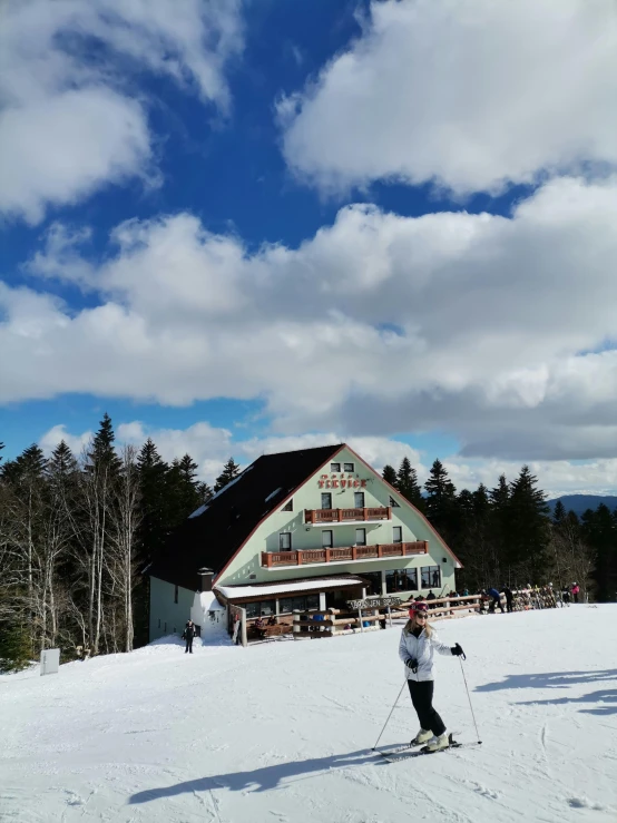 a person on skis standing near a building