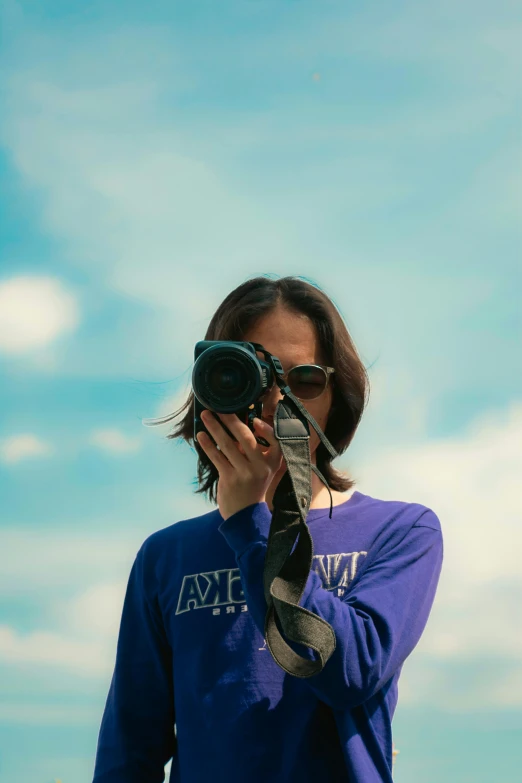 a woman takes a picture with her camera outside