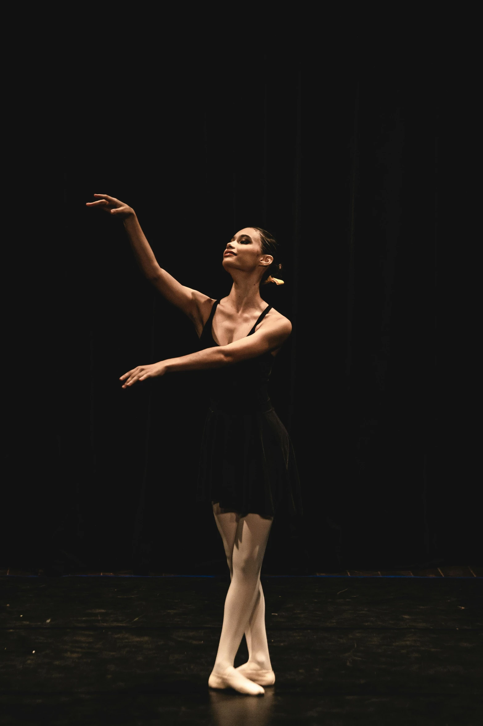 the ballerina in a ballet studio, wearing an overdress