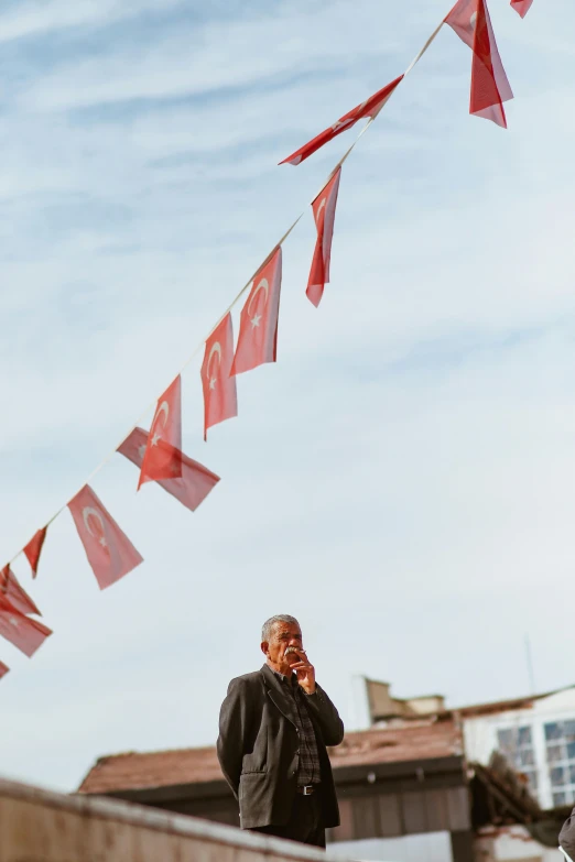 a man in black jacket talking on a cell phone