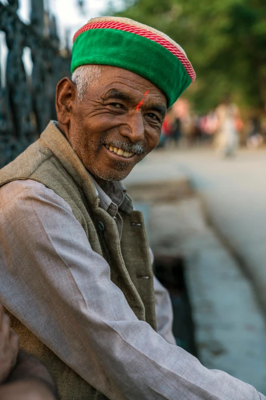 man in turban and colorful shawl looking into camera