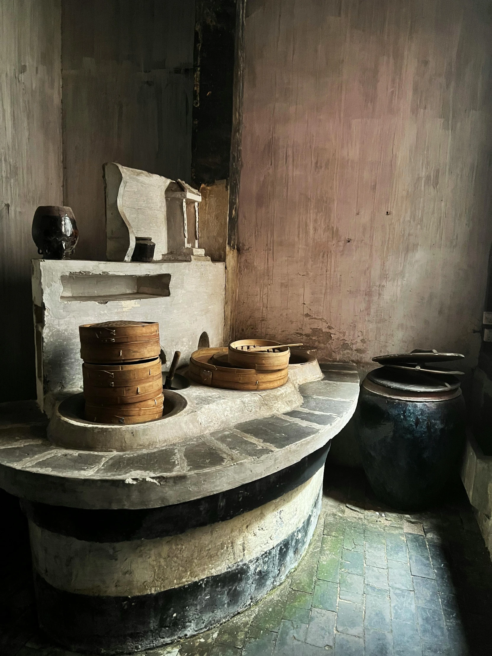 a cement table with two stacks of pots sitting on top of it