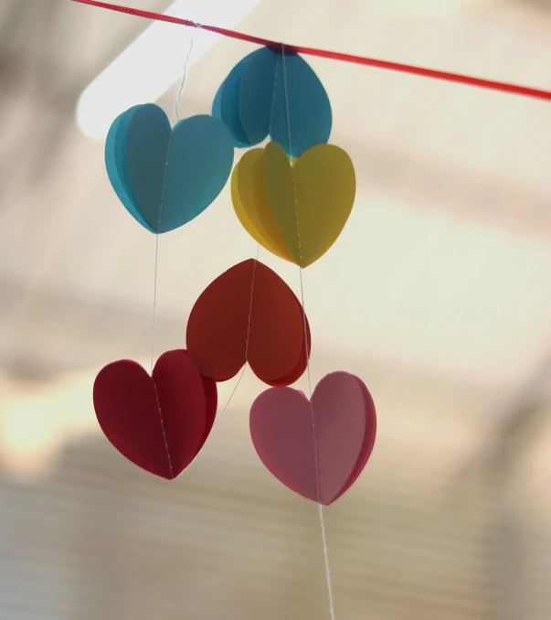 heart shaped paper balls hanging from a string