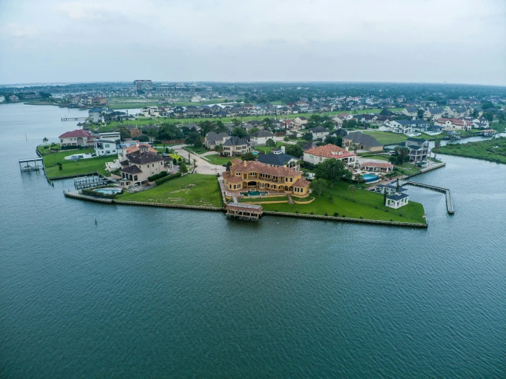 an aerial view of a town, water and coastline