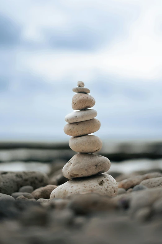 a stack of rocks sitting on top of a rocky beach