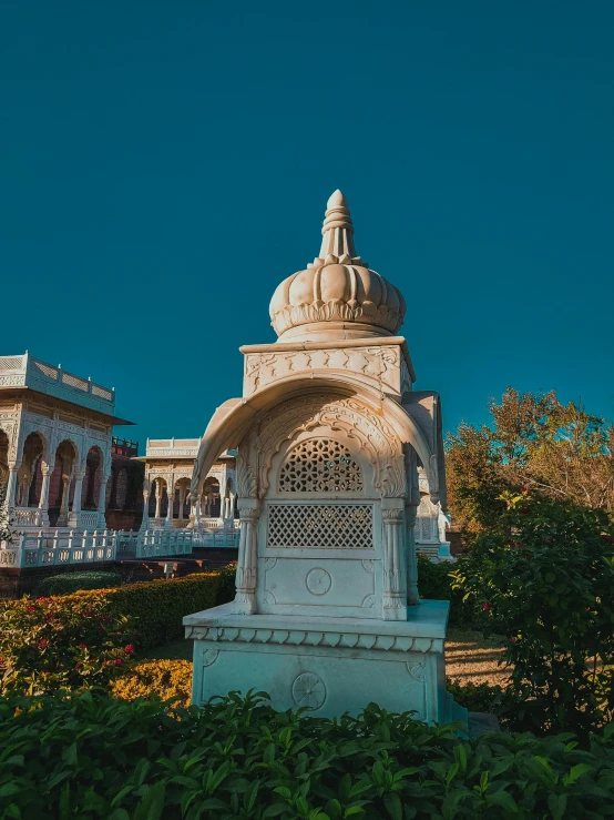 a statue sits in front of a building with an ornately elaborate doorway