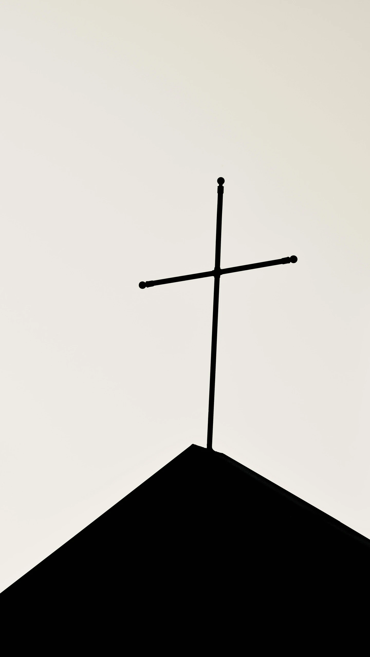 a cross on top of a black roof