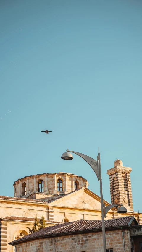 a jet plane flying over a tall brick building