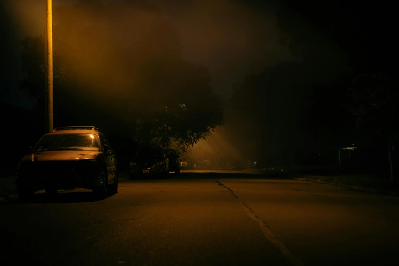 the car is parked at night on the street