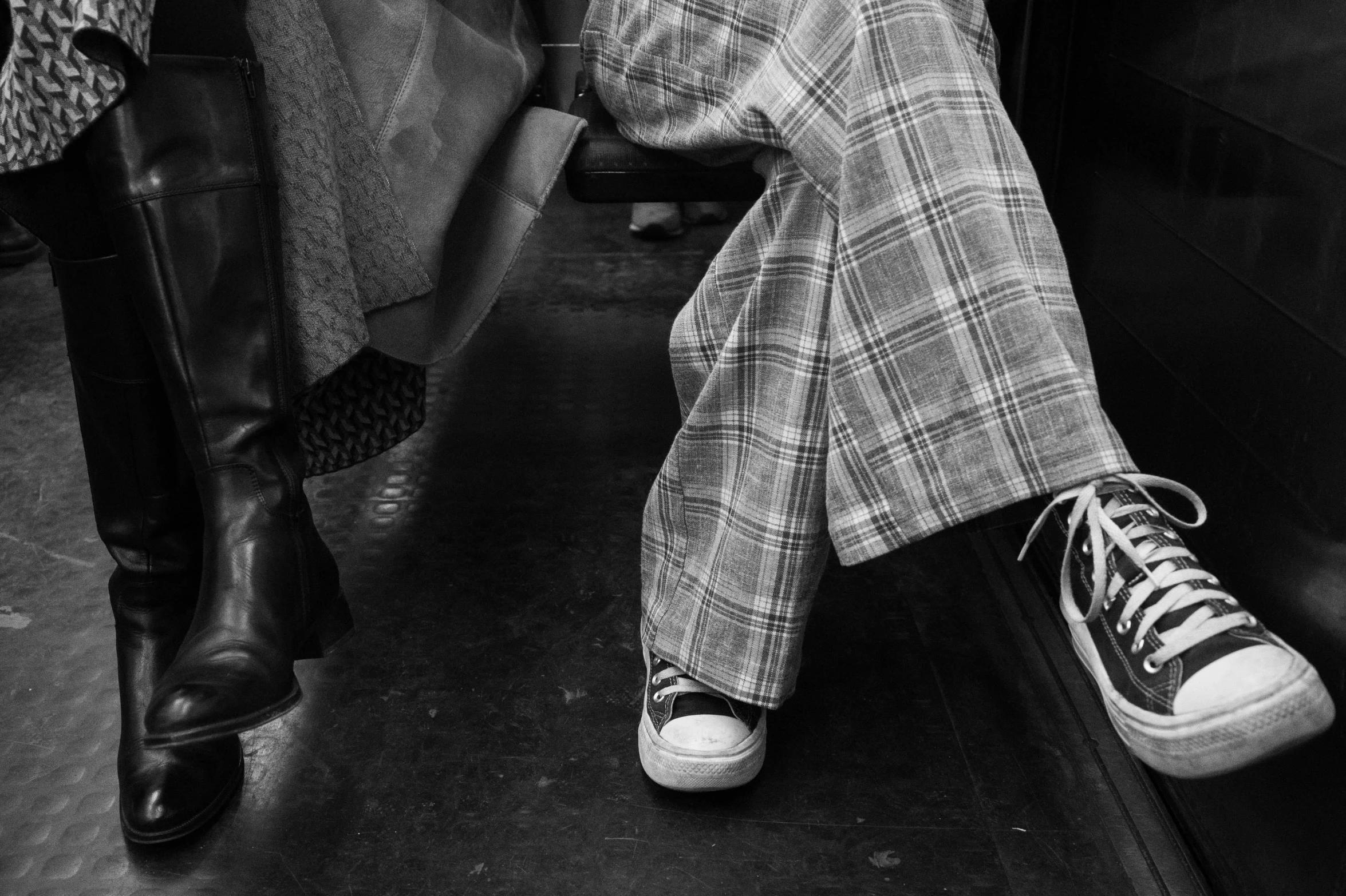 black and white pograph of man with foot in suitcase