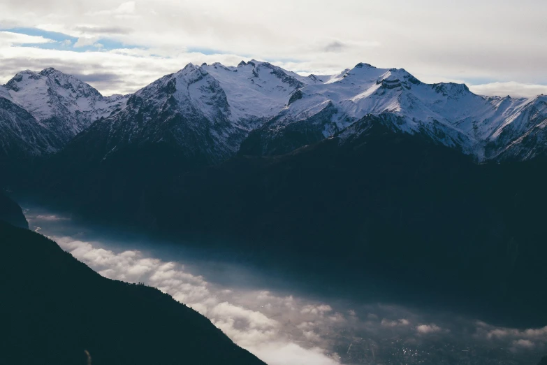 an image of a mountains and clouds from a plane