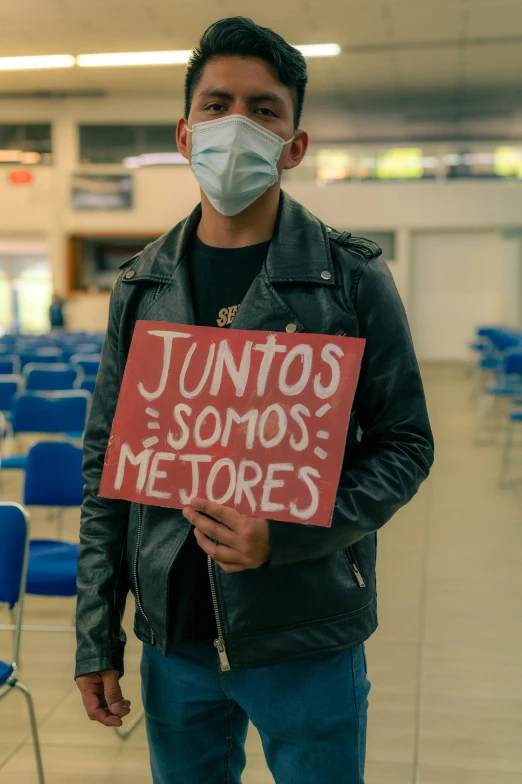 a person standing in an airport with a sign reading,'unto sonos, memories '