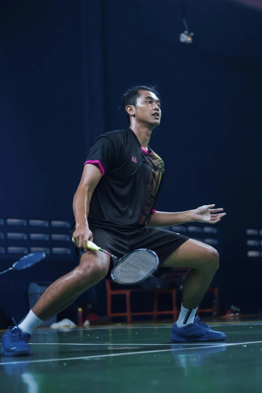 man in motion with a tennis racket on court