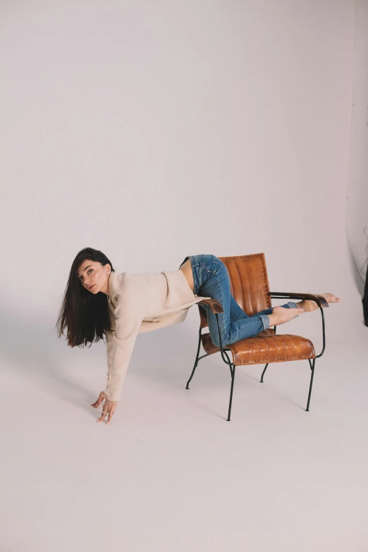 woman leaning over an armchair in a white room