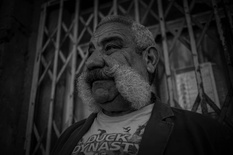 black and white po of an older man with mustache and beard