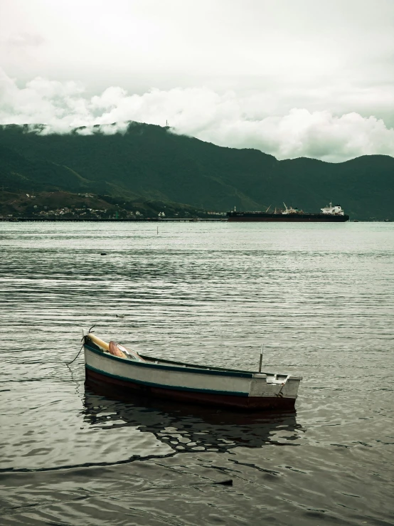 a small boat floating on top of a lake