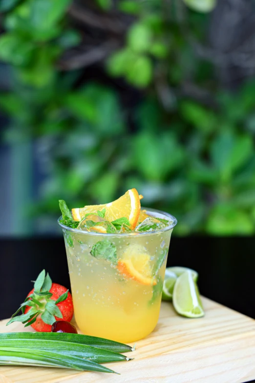 a drink with citrus, mint and orange on the table