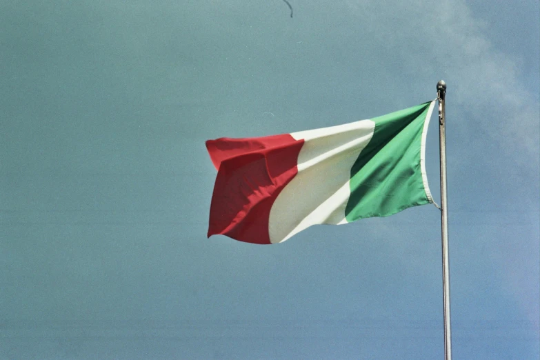 a flag with the colors of italy and the canadian flag on a pole
