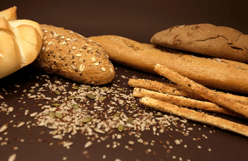 some bread sticks and garlic on a dark surface