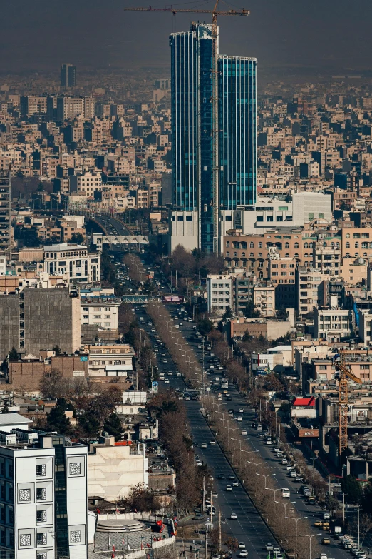 a city is shown with tall buildings and cars