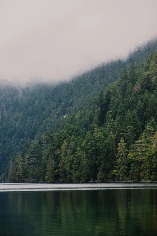 a mountain sitting on top of a large body of water