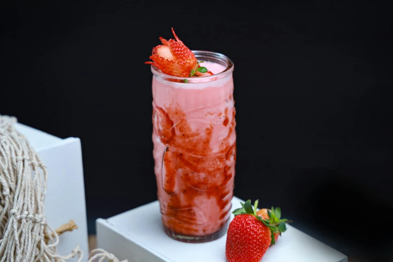 a strawberry filled drink with ice and some strawberries
