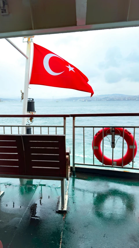 two benches near a pole with a flag at the front